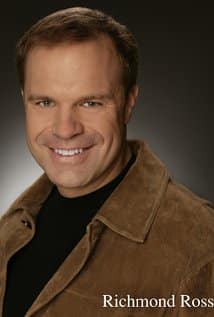 A man with short brown hair smiles at the camera, wearing a brown jacket over a black shirt. The name "Richmond Ross" is written in the bottom right corner.